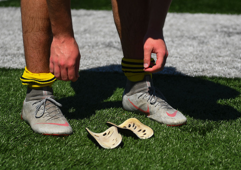 Rock Bridge defender Will Linder removes his shin guards